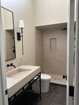 Bathroom vanity with marble top, ramp-style sink, and metal base