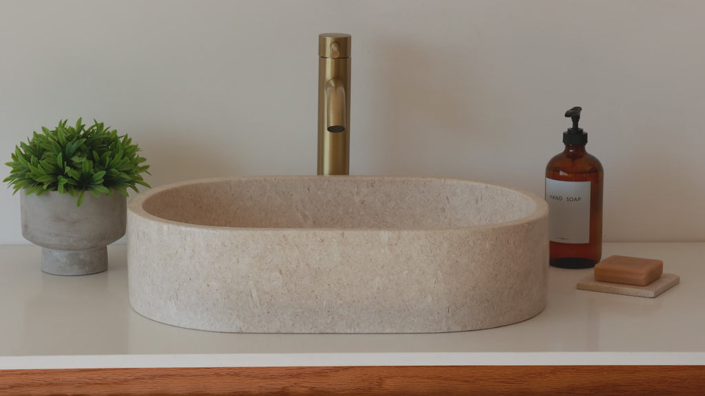 Oval marble vessel sink made from natural stone, modern countertop bathroom sink